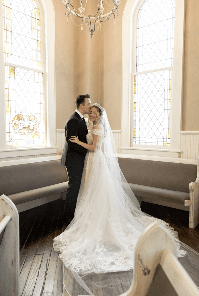 a man and woman kissing in a church